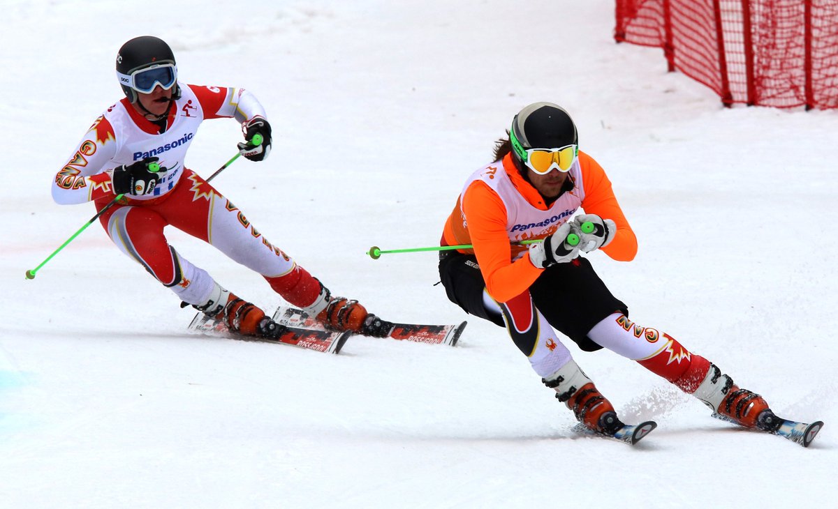 Mac Marcoux and guide racing down ski hill