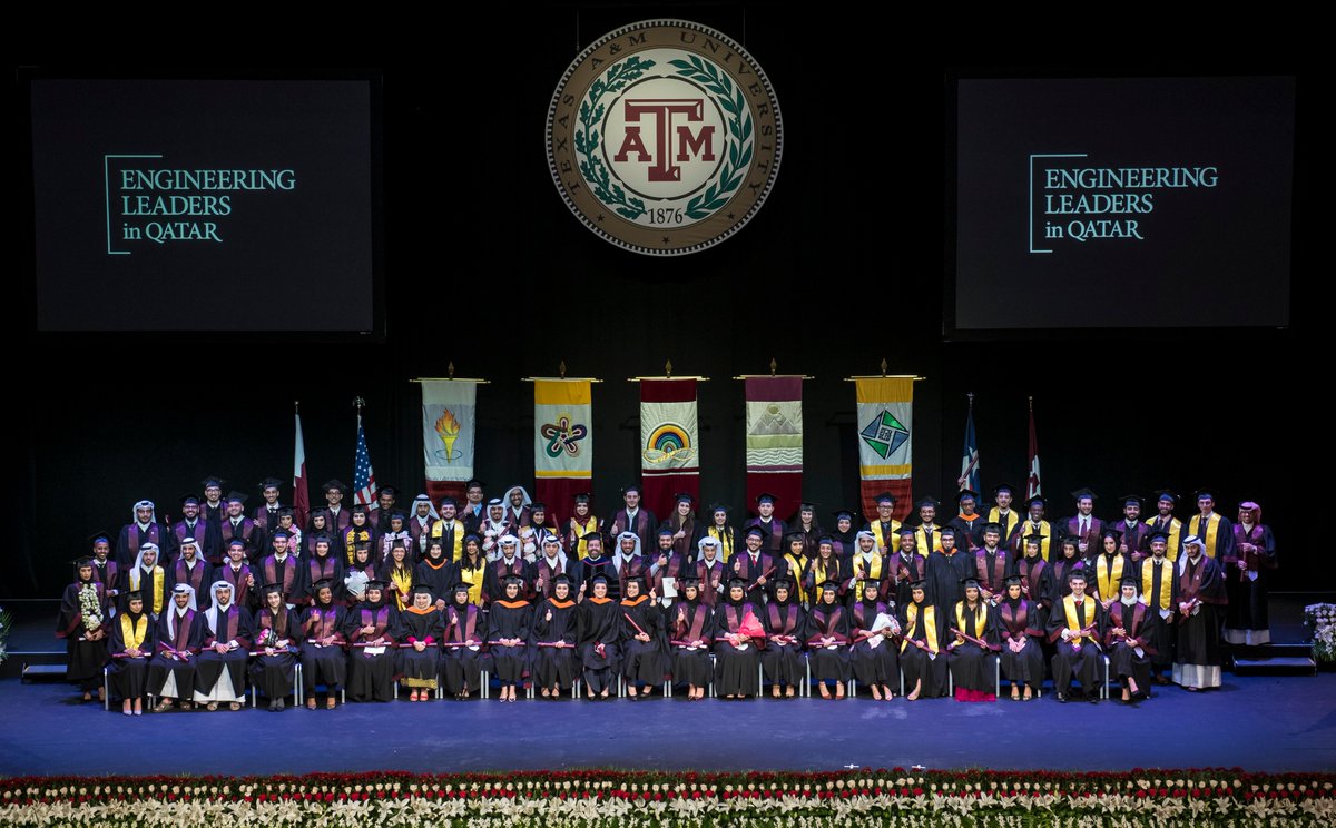 all of the graduates from TAMU Qatar this year seated and standing in a group on stage