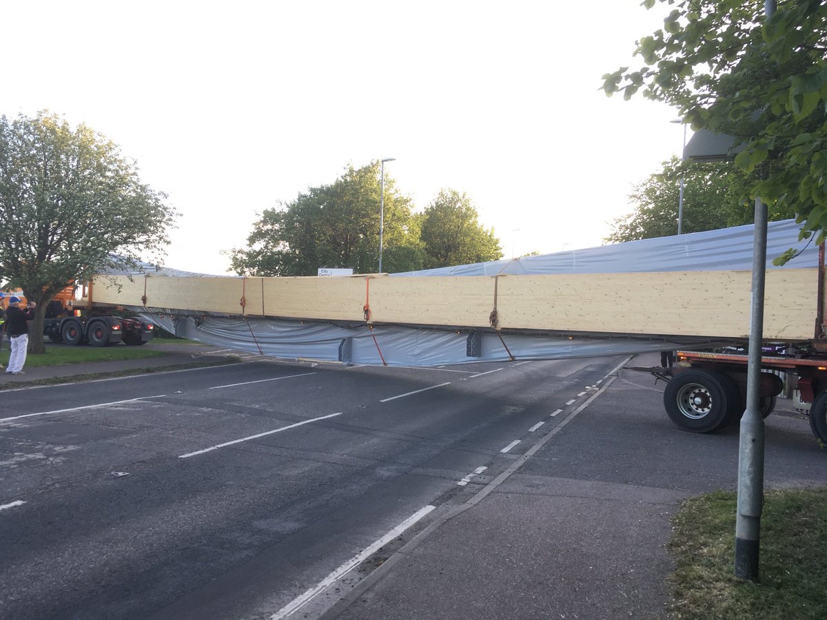 CambsIceArena's tweet photo. Three 10 tonne, 38m glulam beams, longest in the UK (we believe!), arrived from Germany yesterday having travelled by land &amp; sea for 36 hours. Thank you to everyone involved, including Cambridgeshire Police and Marshalls, in ensuring we safely manoeuvred the beams onto our site. https://t.co/4qWb6PCqo3
