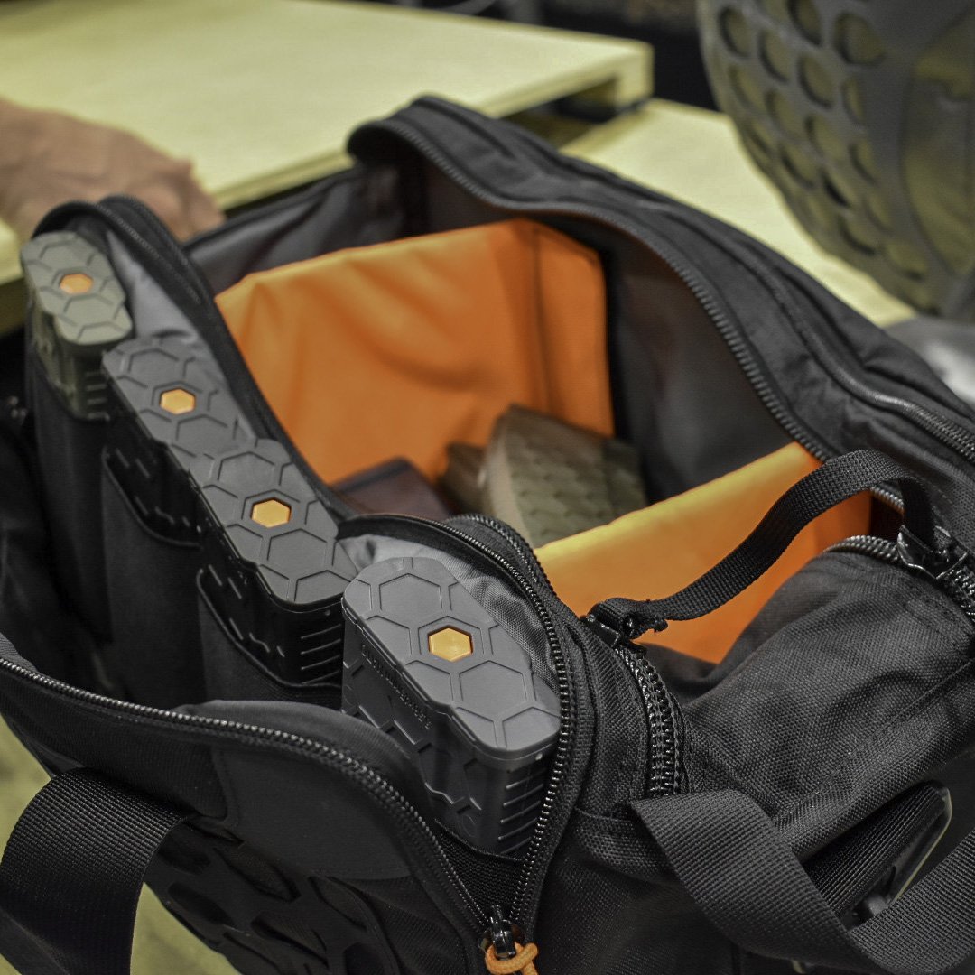 Hexmags's tweet photo. What do we have here? The SENTRY Sentinel Pistol Range Bag loaded up with some @hexmag magazines strutting the orange #hexid system and SENTRY's Tumalo Extreme Weather Resistant Bag complete with the TEN80 system. https://t.co/Q8xxpWGYrD