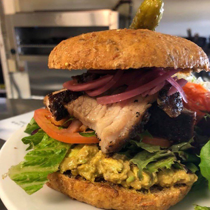 millcreekcafeab's tweet photo. Smoked salt and pepper pork belly served on a homemade bun topped with pickled onions, guacamole, tomato and spring mix. https://t.co/MV6AM4SVHi