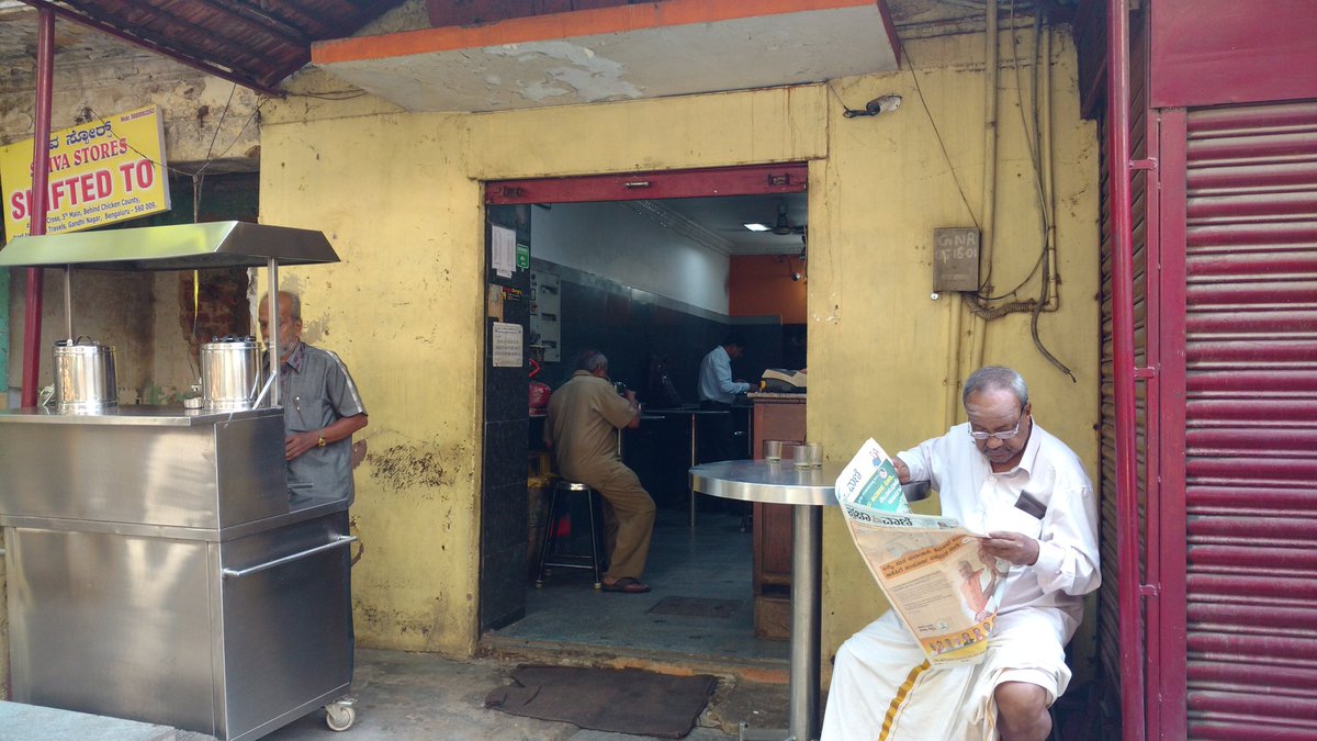 VishKVarma's tweet photo. It's breakfast and newspaper time in Bengaluru right now. Voting expected to pick up pace in the next few hours. A scene from Gandhinagar. @IndianExpress #LiveInKarnataka https://t.co/J8tjE10Hs0