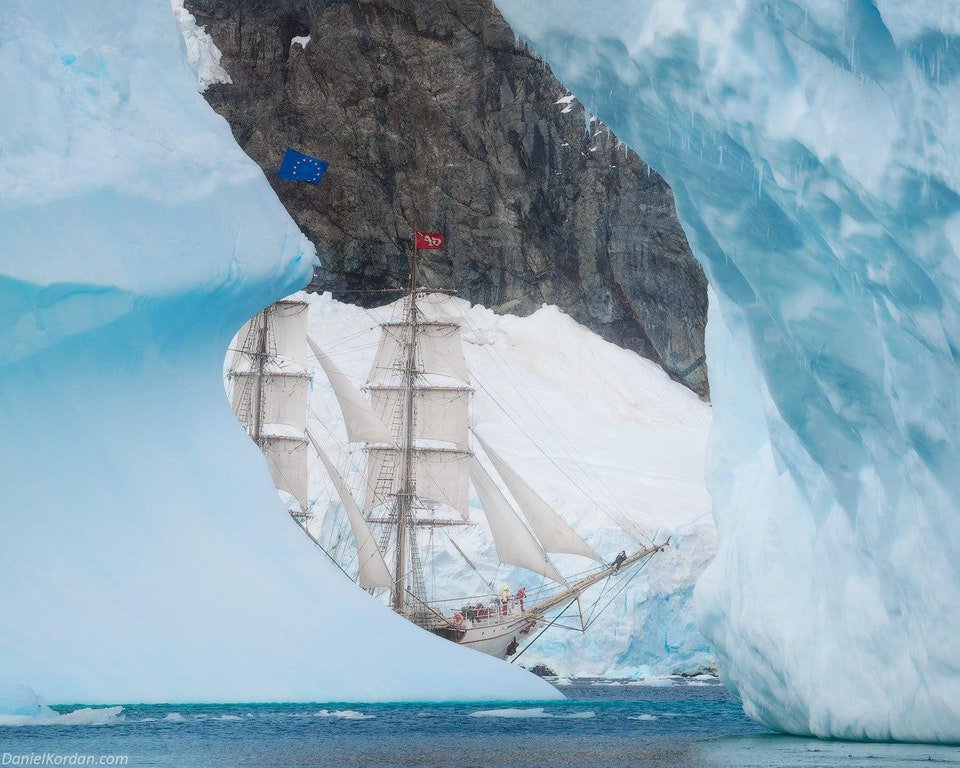 Rainmaker1973's tweet photo. The Europa is a steel-hulled barque registered in the Netherlands. In this amazing photo by Daniel Kordan, it gracefully sails among icebergs of Lemaire channel in Antarctica, creating a stunningly unexpected perspective https://t.co/OUrfF364Xs | https://t.co/PHrxuDPNr0 https://t.co/gdCqGqtL5n