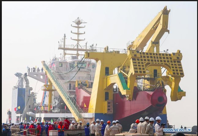 adam_tooze's tweet photo. China’s magic island maker - the cutter-suction dredger MV Tian Kun Hao named after "a legendary enormous fish which can turn into a mythical bird”. The boat can dig 6000 cubit meters of sand/silt = three standard swimming pools - per hour. https://t.co/gqHT8jr1gE