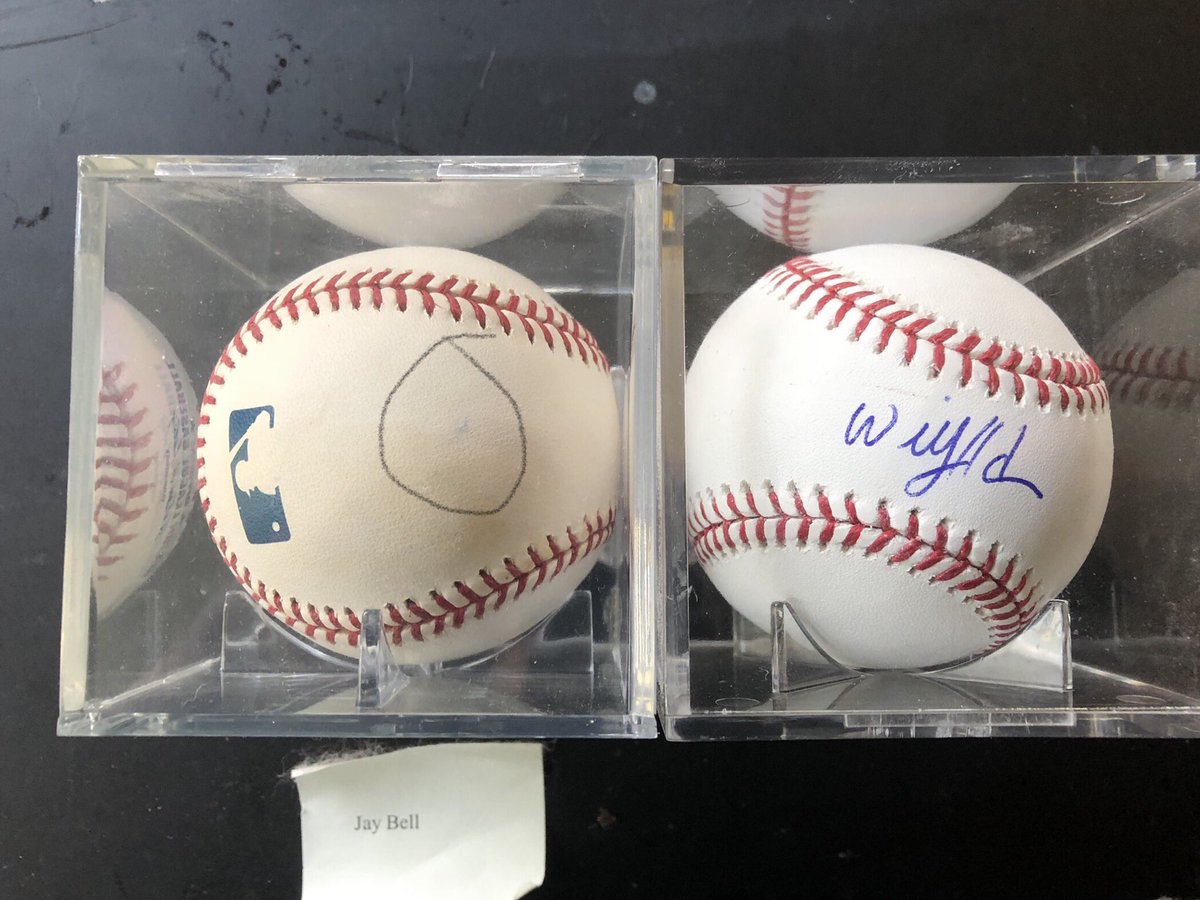 comicKentPerry's tweet image. Today, the Willie Adames autographed baseball I received in a contest for @RaysRadio affiliates joined the autographed Jay Bell ball that has been in a place of honor in my office for many years. (Circled is the slight smudge of ballpoint pen left on the Bell ball.) Thanks, Rays!