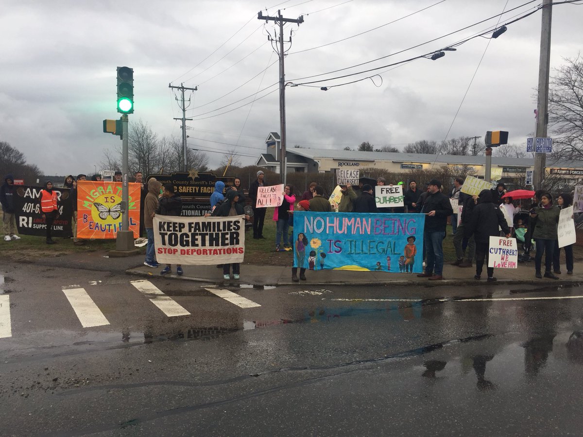 FangCollective's tweet photo. Over 50 people demonstrating here in Plymouth where hundreds of people are being held by ICE, including Cuthbert Bonnie. #ReleaseCuthbert #ShutDownICE https://t.co/tnNFuVtzNM