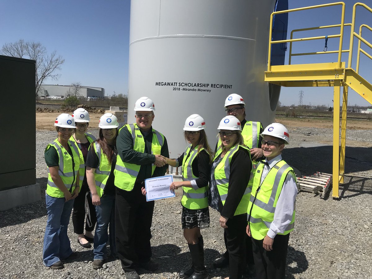 MichaelLBrand's tweet photo. Annie Mowrey receives ValFilm Megawatt Scholarship at the base of the turbine that now proudly displays her name for winning the scholarship.  Annie’s essay shared the connection between nursing and the STEM field.  Congratulations! https://t.co/Qyuokf5P2s