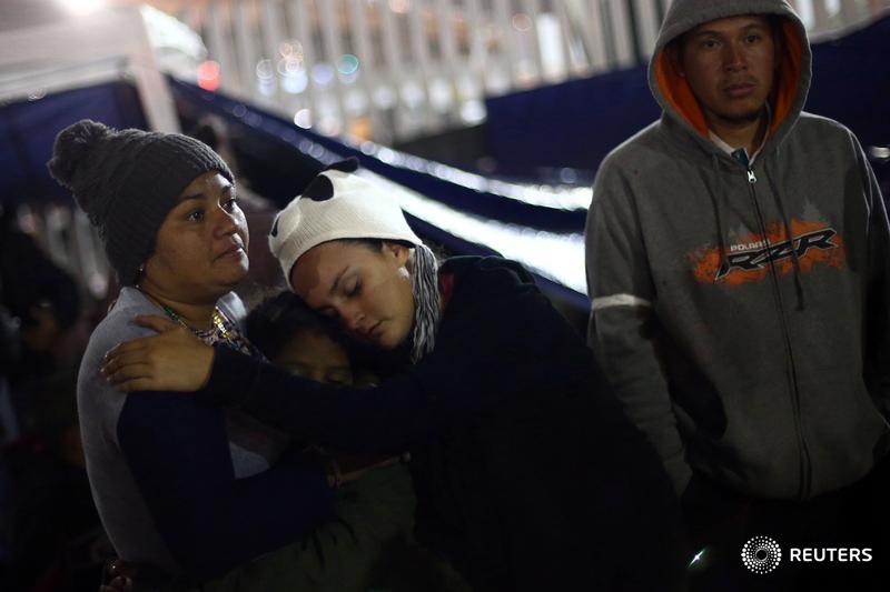 Reuters's tweet photo. Entry of eight women, children to U.S. from Mexico gives hope to hundreds on the border, some of whom have traveled 2,000 miles across the country to seek asylum https://t.co/29nFV23aiz https://t.co/YVAFWKWGZH