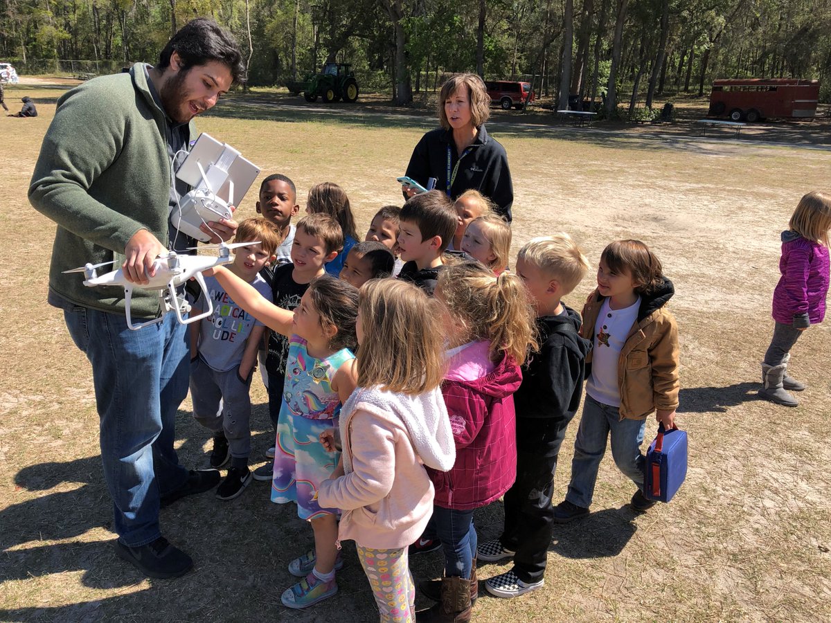 UFRinkerSchool's tweet photo. Dr. Gheisari, Dr. Costin, and PhD Student, Ricardo Eiris, attended the Archer Elementary Career Day. Students got to interact with the UAV and Virtual Reality Technology while wearing their own, mini Rinker School hardhats!
 #UFRinkerBuilds #BuildingGenerations https://t.co/CBl3A7K9gz