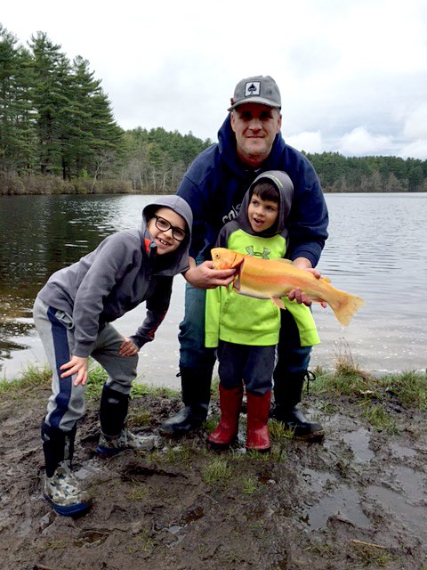 angler with golden rainbow trout