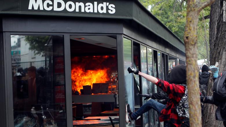 cnni's tweet photo. More than 100 people remained in custody in Paris on Wednesday after annual May Day protests turned violent, police said. https://t.co/cxCYY6OnMc https://t.co/WNOxAAmmr5