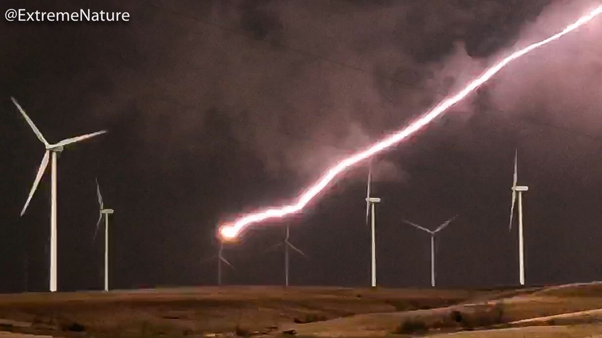 Lightning strikes the blade of a large wind turbine at smokey hills