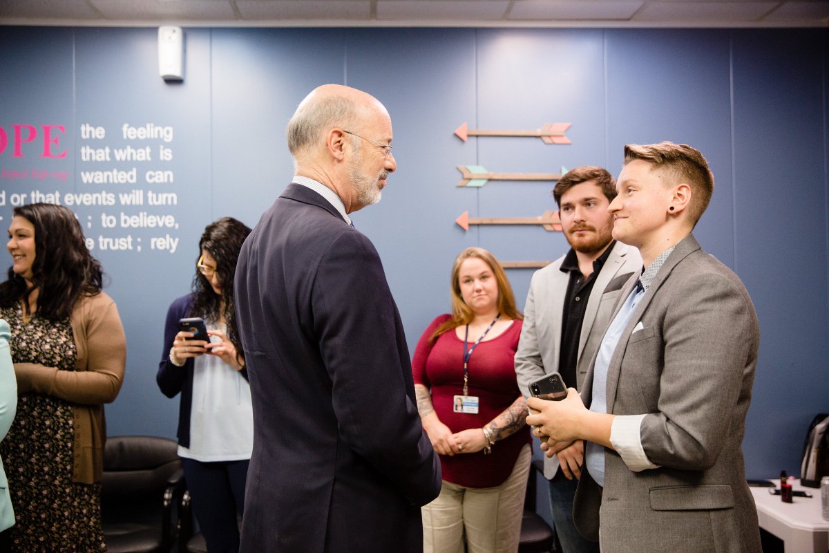 Image of Governor Tom Wolf speaking to people in a blue room.