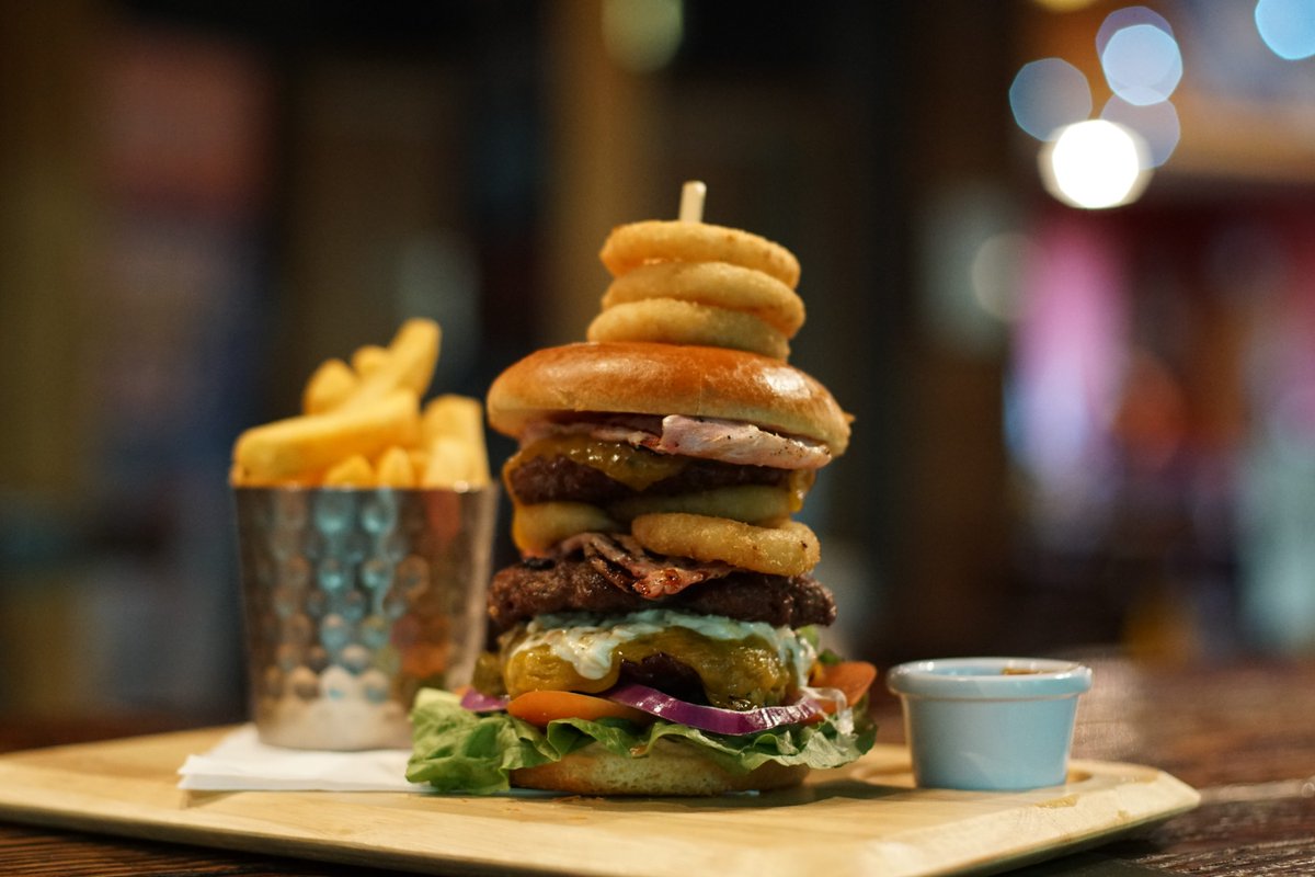 Have you tried one of our delicious #burgers yet?  Why not try The Hoff (pictured) - Three prime 4 oz 100% #ScottishBeef burgers sandwiched between burger buns, double Swiss Cheese, double bacon, double onion rings, house pickles, coleslaw & green salad.  #FoodPorn