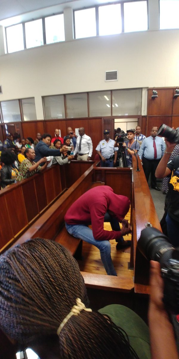 TeamNews24's tweet photo. The man accused of murder in the #ZolileKhumalo matter smiled just before covering himself up. (@kaveels) https://t.co/4pUyNp3uP7