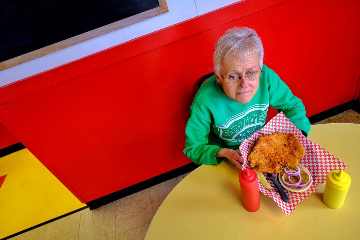 Goldie’s Ice Cream Shoppe in Prairie City, Iowa: When my pork tenderloin sandwich arrived, the manager, Marilee Magg, took one look at it and ordered, “Get him a bigger one!” tastingtable.com/travel/nationa… <a href="/Travel_Iowa/">Travel Iowa</a> #ThisIsIowa