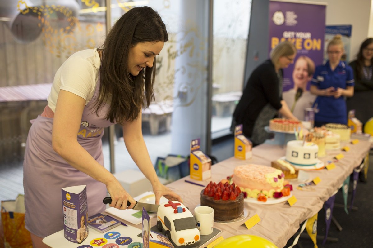 GOSHCharity's tweet photo. A big thank you to @SophieFaldo for choosing the champion at our hospital staff #BakeItBetter bake sale – congrats to GOSH volunteer Noreen on her fab creation. Sophie also visited the Panther Ward playroom to meet one-year-old Ashton and his mum Katie! https://t.co/kqOzUbCQMq https://t.co/qHhxCETLpp