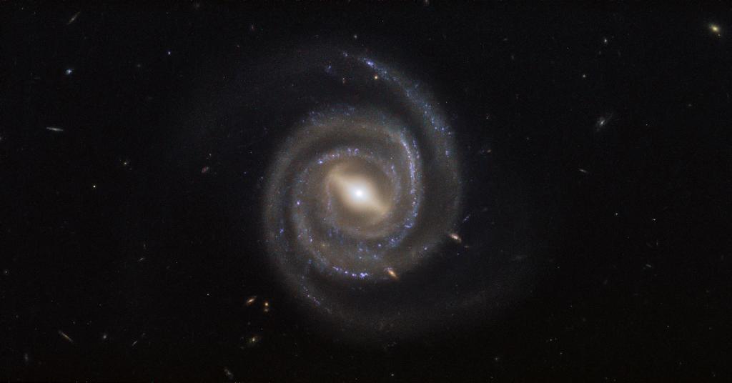 NASAHubble's tweet photo. #MayTheFourth be with you if you find yourself facing down an Imperial TIE fighter, which looks a lot like the center of this spiral galaxy, named UGC 6093. Beautiful spiral arms swirl away from the fighter-shaped bar of stars crossing the galaxy's core: https://t.co/68stvBqmlT https://t.co/FL1jzbuMA9