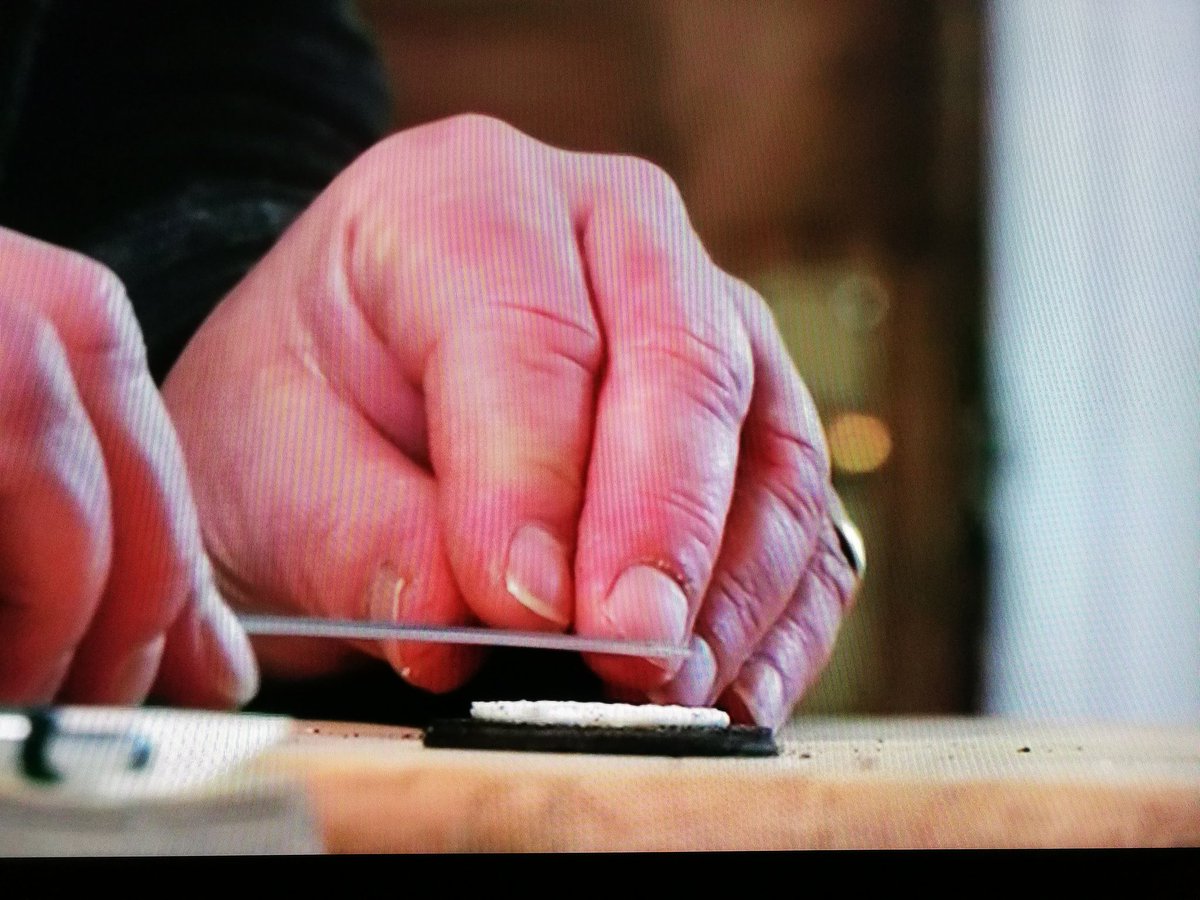 Today. A man measuring his biscuit filling with a ruler and recording it in a book.