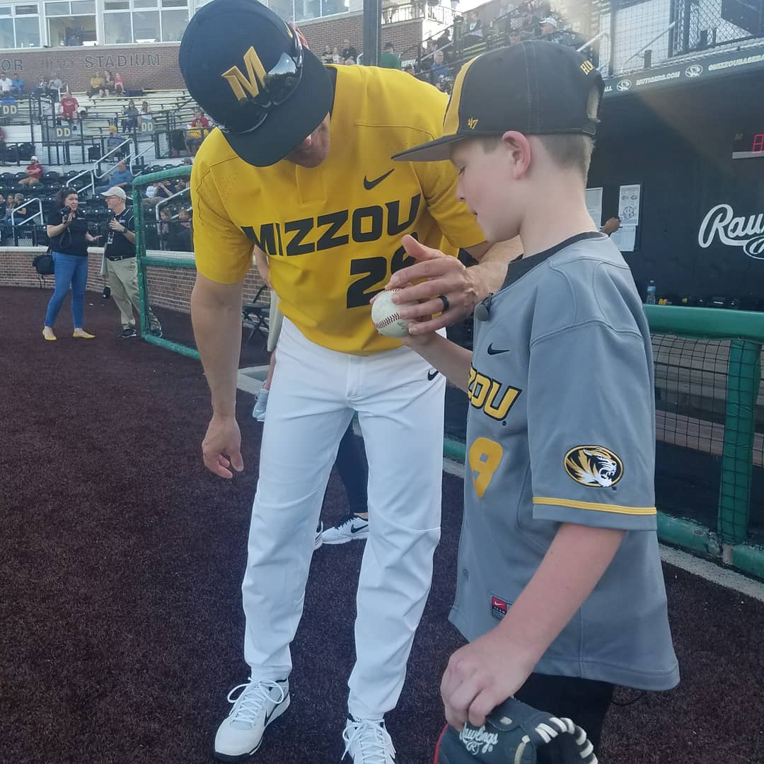Mizzou's tweet photo. First pitch from a future @MizzouBaseball player?! (He already has the jersey.)Thanks to #TigerOT for making Hunter's dream to play baseball come true 😎 ⚾ https://t.co/DZQGWWhX05