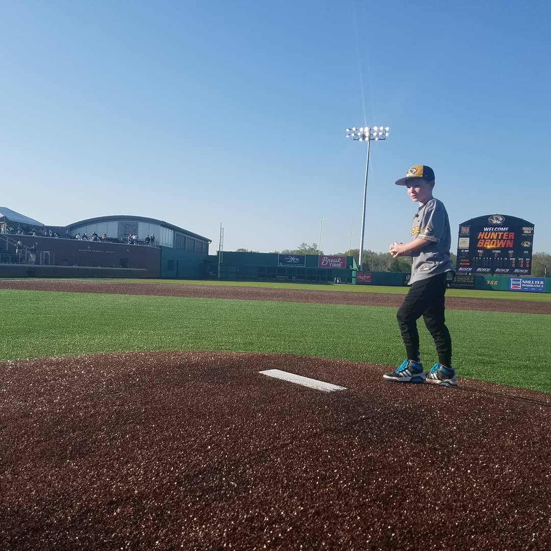 Mizzou's tweet photo. First pitch from a future @MizzouBaseball player?! (He already has the jersey.)Thanks to #TigerOT for making Hunter's dream to play baseball come true 😎 ⚾ https://t.co/DZQGWWhX05