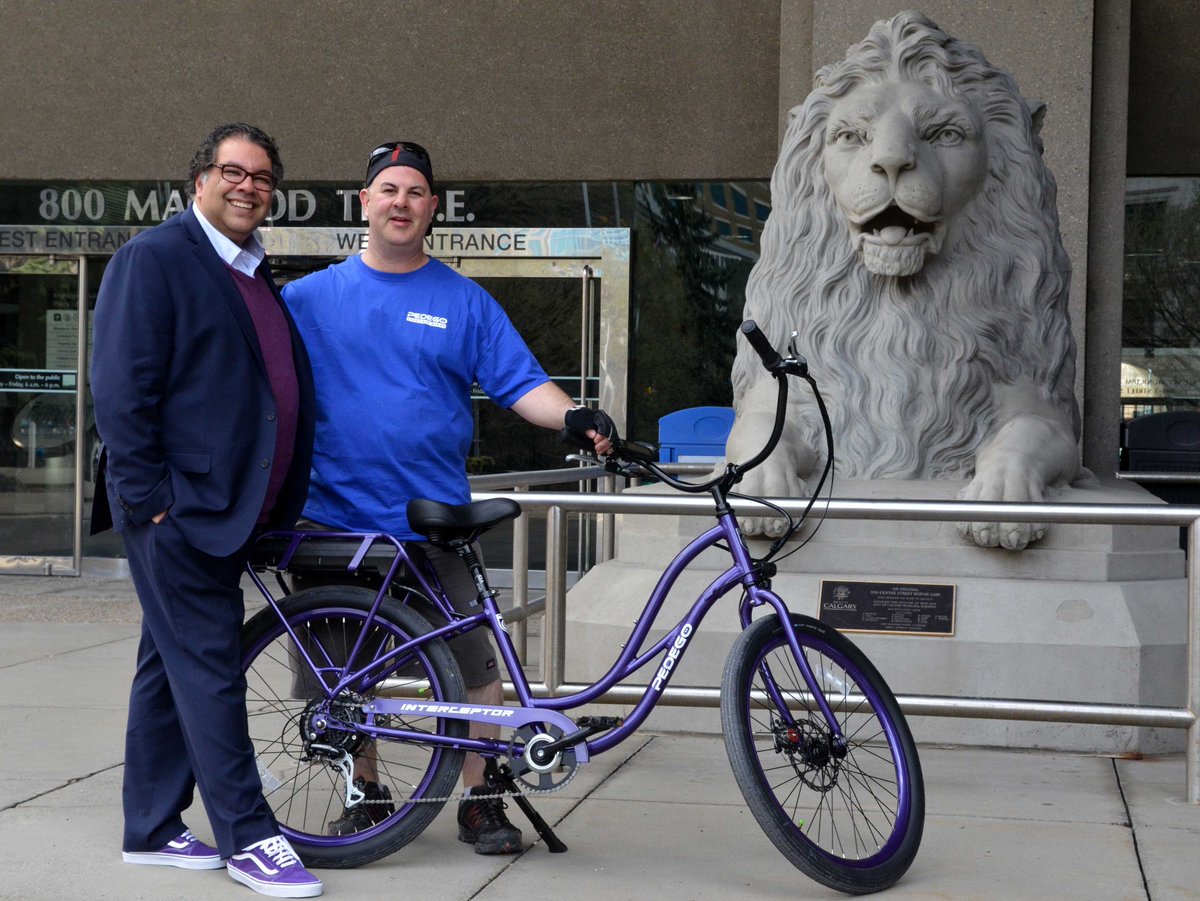 PedegoCalgary's tweet photo. We had the pleasure of adding a little extra purple to @nenshi 's day with our #Pedego Step-Thru Interceptor. Purple represents Canada's future growth - join us tomorrow for our Grand Opening at Eau Claire Market.  #hellofun https://t.co/4yCgGdXcQC