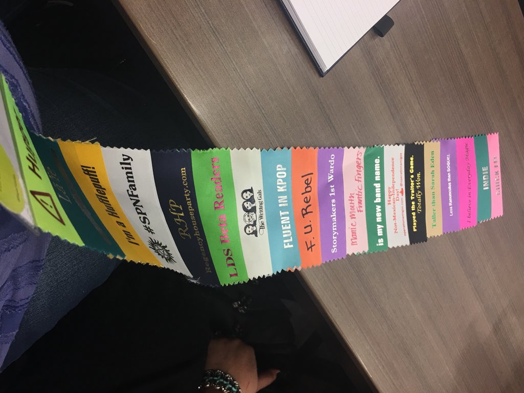 MsMaggieDecker's tweet photo. The awkward introvert is playing at extrovert this weekend. I now have a tail of happy badges. #AuthorsIRL #Storymakers18 https://t.co/xUhPT6Xhh4