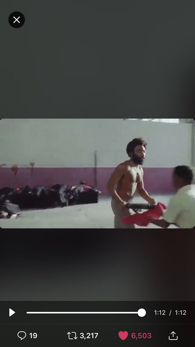_rMichaeld's tweet photo. Placing the guns carefully on red cloths is such a subtle but glaring criticism of the fact that even after such atrocities we still value such deadly weapons over the lives of innocents. @donaldglover #ChildishGambino #ThisIsAmerica #Dontcatchyouslippin https://t.co/9IS0uF9Vly