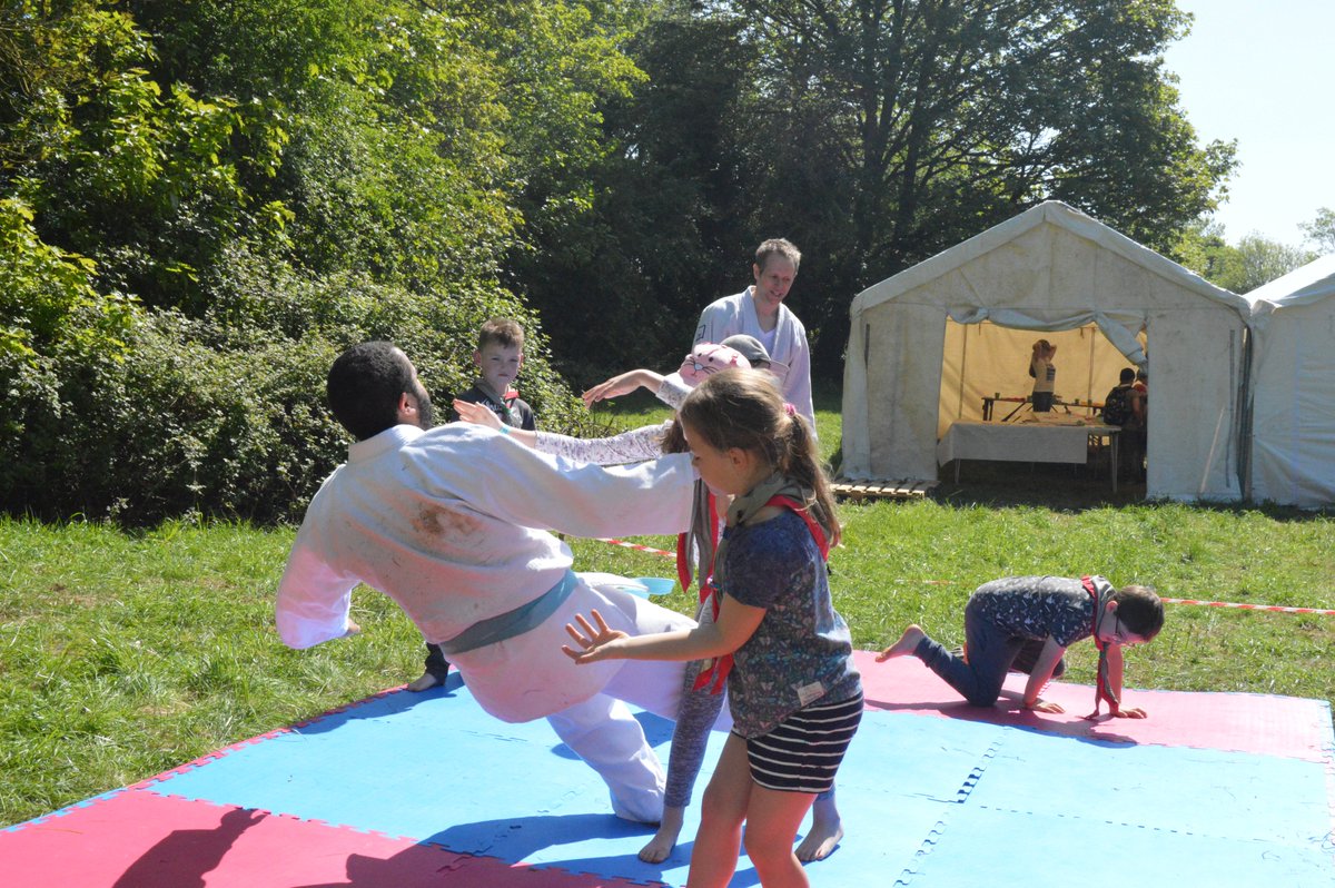 BathScouts's tweet photo. Another perfect day for activities, including the all-new grass sledging and some new skills from our jiu-jitsu friends, at #OnceUponACamp. A little warm, but thankfully our camp volunteers from the Scout section are delivering water around the site. https://t.co/NUlrTsfFAu