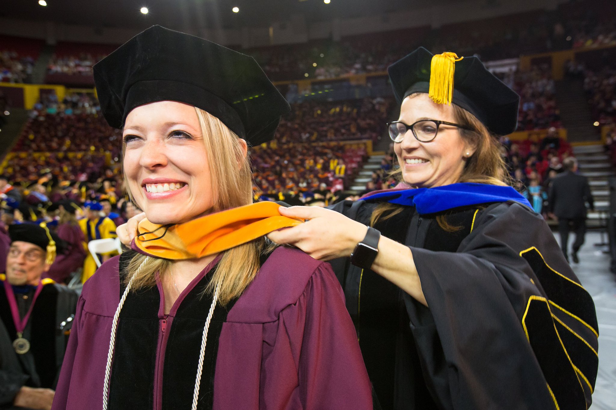 Graduates of the Arizona State University Class of 2013 smile during their  graduation ceremony in Tempe,
