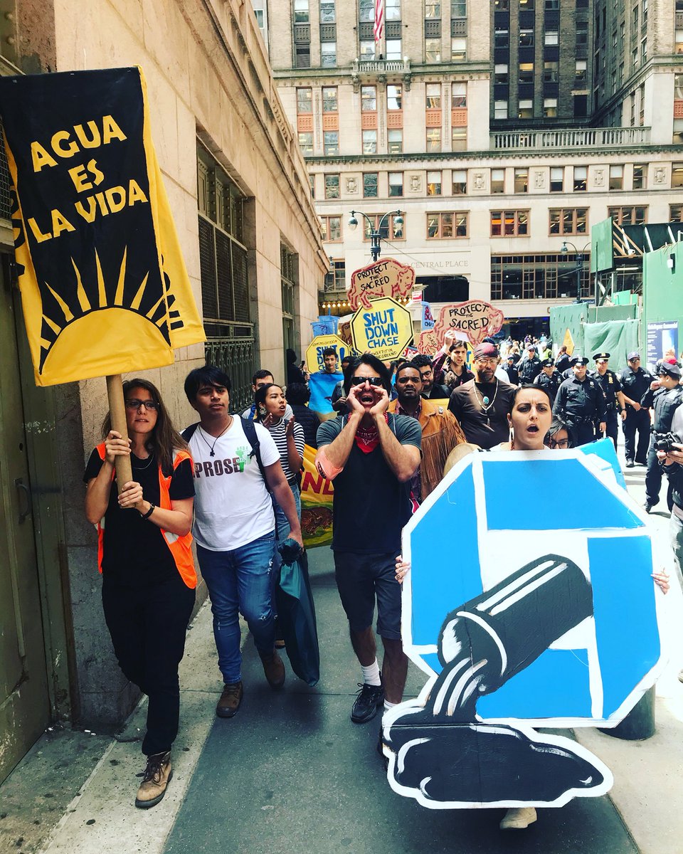 occupytheory's tweet image. Action against Chase Bank now, around a hundred and growing, starting in Grand Central. Direct Action with American Indian Community House and allies. With a settler colonial state you #decolonizethisplace
#shutdownchasenyc
#keepitintheground
#live #nyc