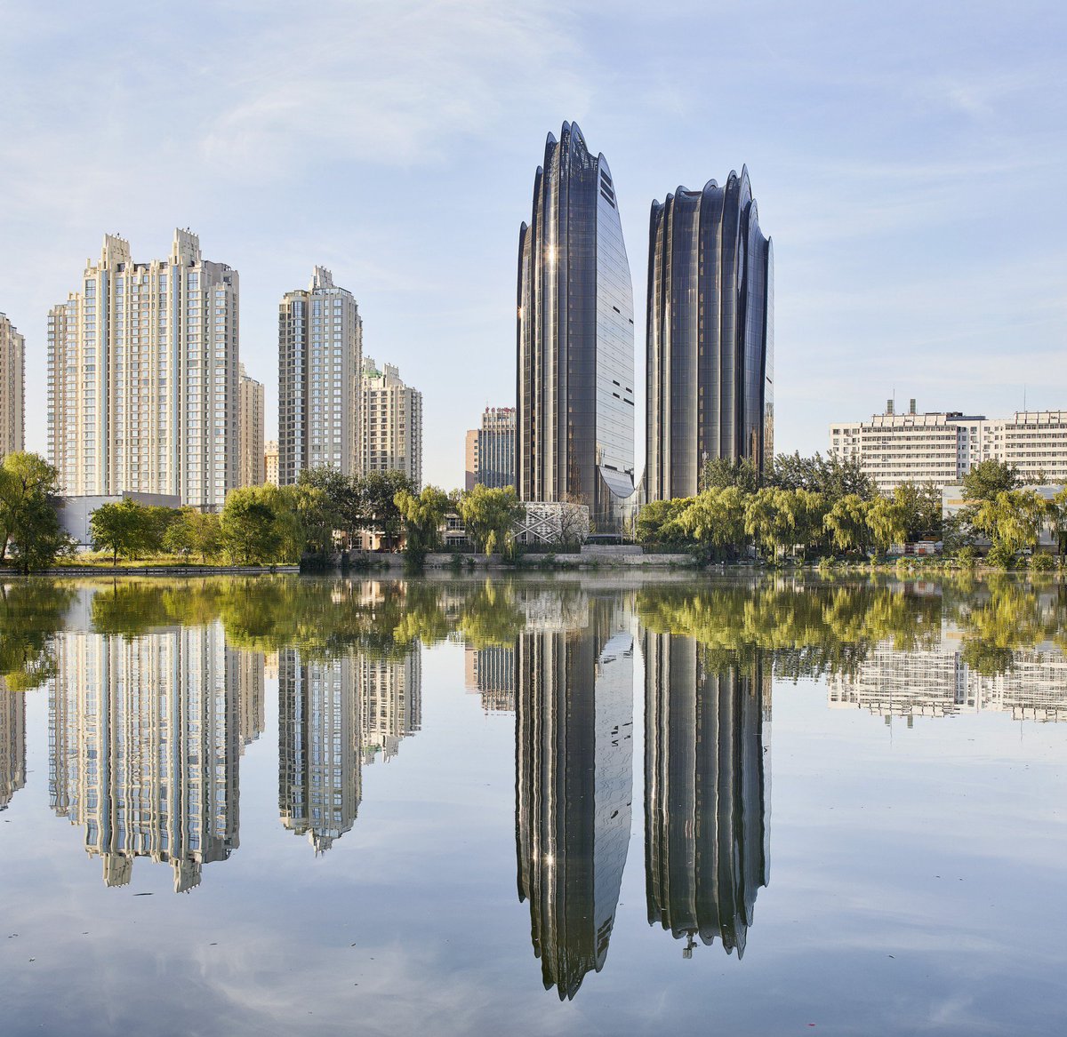 discoverbeijing's tweet photo. Chaoyang Park Plaza, Beijing.
Photos capture the relationship between the city of Beijing and the Chaoyang Park Plaza skyscraper, designed by MAD Architects,the studio headed by architect Ma Yansong.They offer an image of architecture in its urban setting. https://t.co/NcgTrWgwIJ https://t.co/8qWcYi9vC7