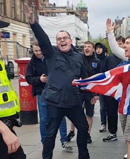 80_mcswan's tweet image. The man in the photo is Andrew Reid a Nazi supporting Unionist has been spotted by his employers giving Nazi salutes and has now been sacked 
Nazis &amp;amp; British ethnic nationalists have no place in society