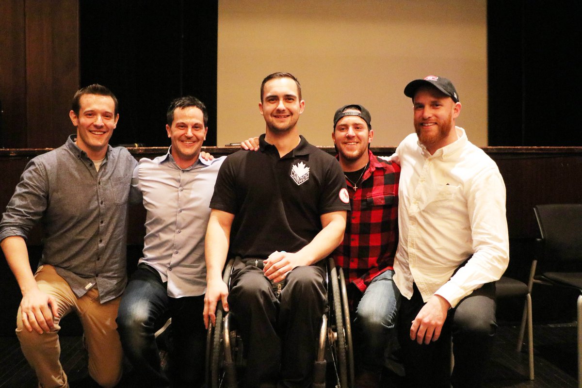 Host Anthony McLachlan, Producer Ted Cooper, Para Ice Hockey player Tyrone Henry, Para Skier Mac Marcoux and Videographer Matt McGurk smile with their arms around each other.