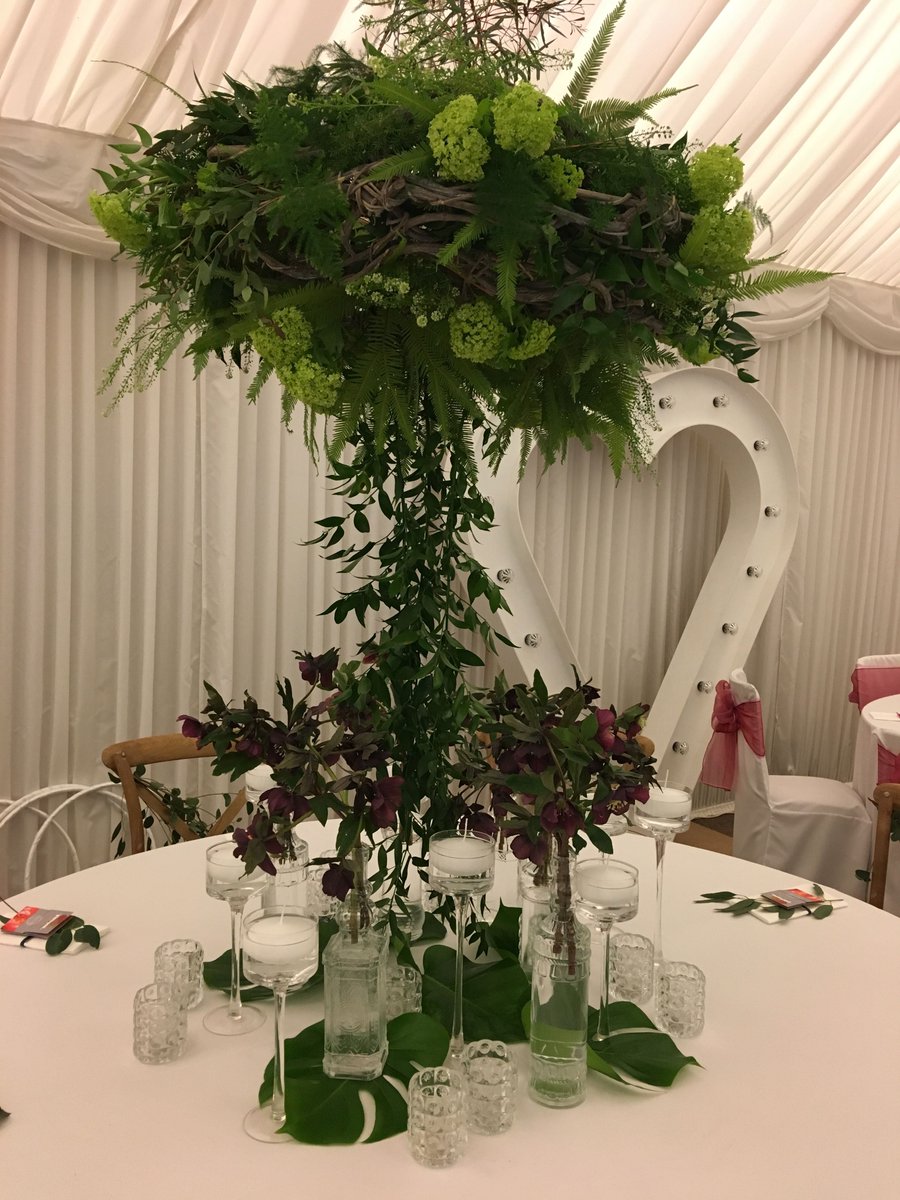 A hanging table centre spilling down onto the table. A mixture of these designs and more simple low designs will really give a textural feel to your wedding day.