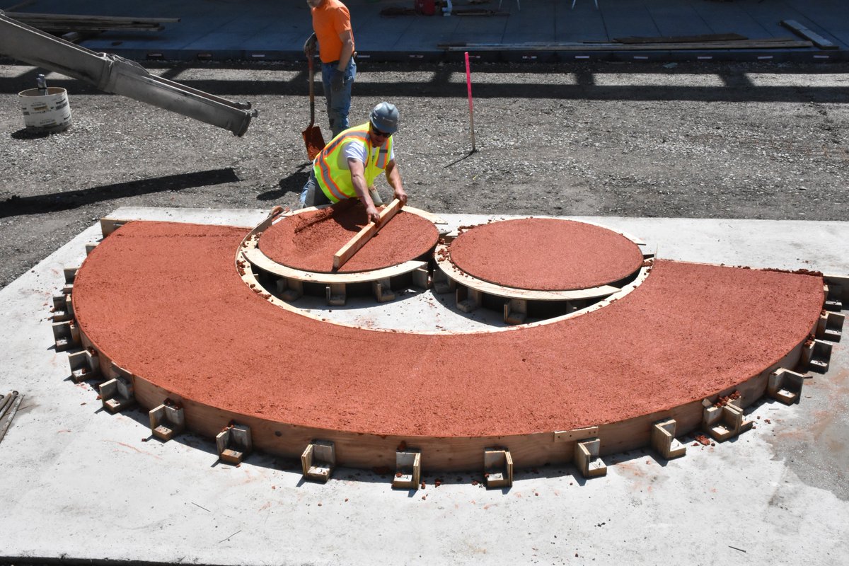 Summerfest's tweet photo. The iconic smile at the @amfam North gate has been poured with help from @EUA and @cgschmidtinc! We can't wait until you can see it in person! https://t.co/5JEjBdpTwa