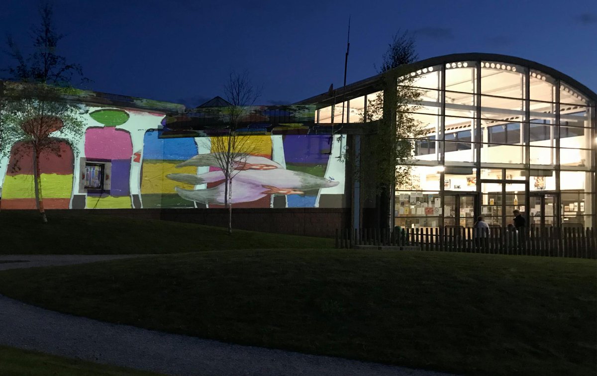 TannahillCentre's tweet photo. Look at how colourful the Tannahill Centre looked on Saturday with artwork from children and young people being projected onto the building by artist Caroline Campbell! #TannahillThreads https://t.co/Efow6DGbZ1