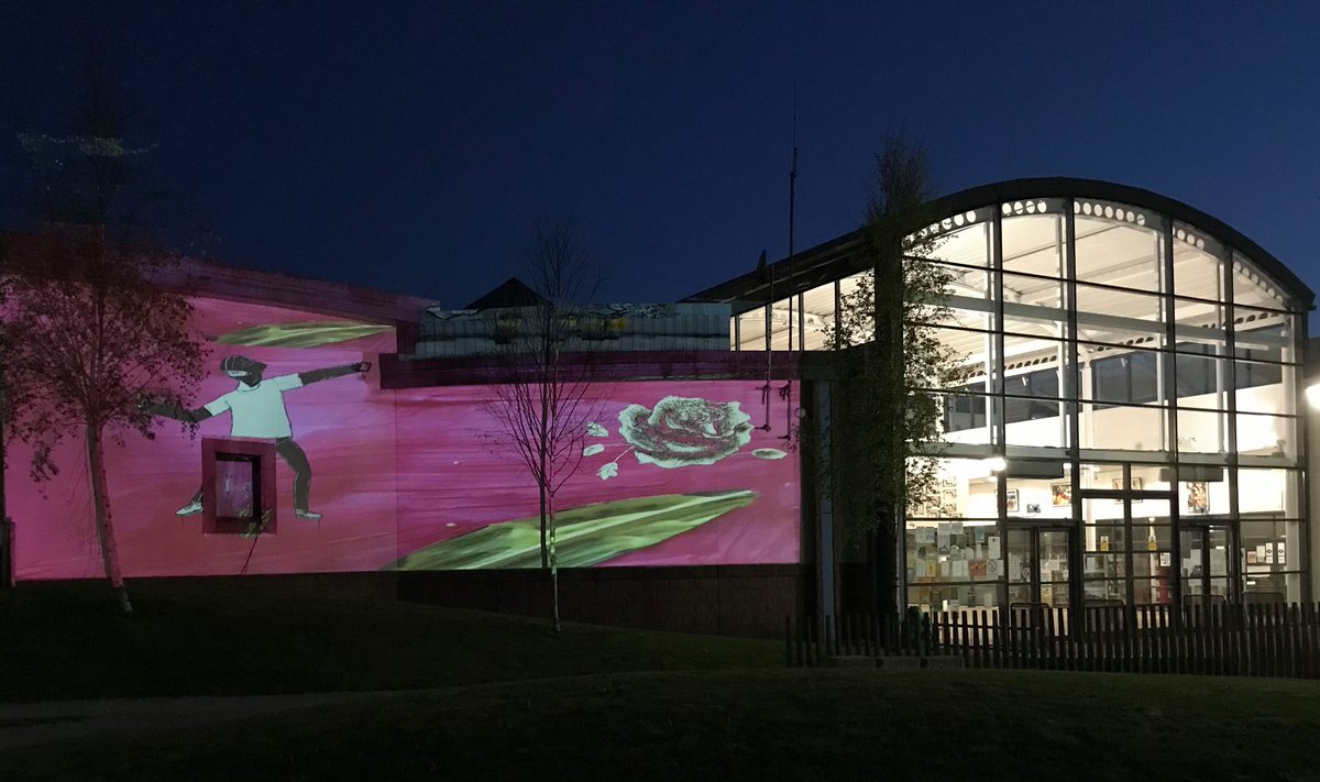 TannahillCentre's tweet photo. Look at how colourful the Tannahill Centre looked on Saturday with artwork from children and young people being projected onto the building by artist Caroline Campbell! #TannahillThreads https://t.co/Efow6DGbZ1