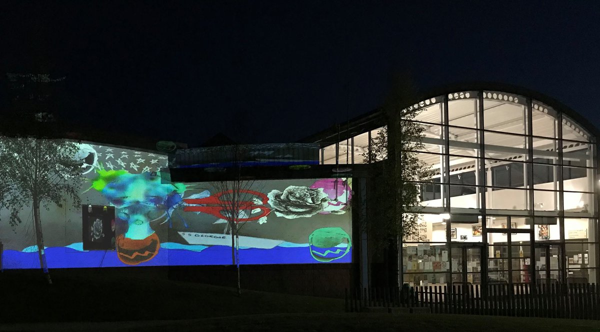 TannahillCentre's tweet photo. Look at how colourful the Tannahill Centre looked on Saturday with artwork from children and young people being projected onto the building by artist Caroline Campbell! #TannahillThreads https://t.co/Efow6DGbZ1