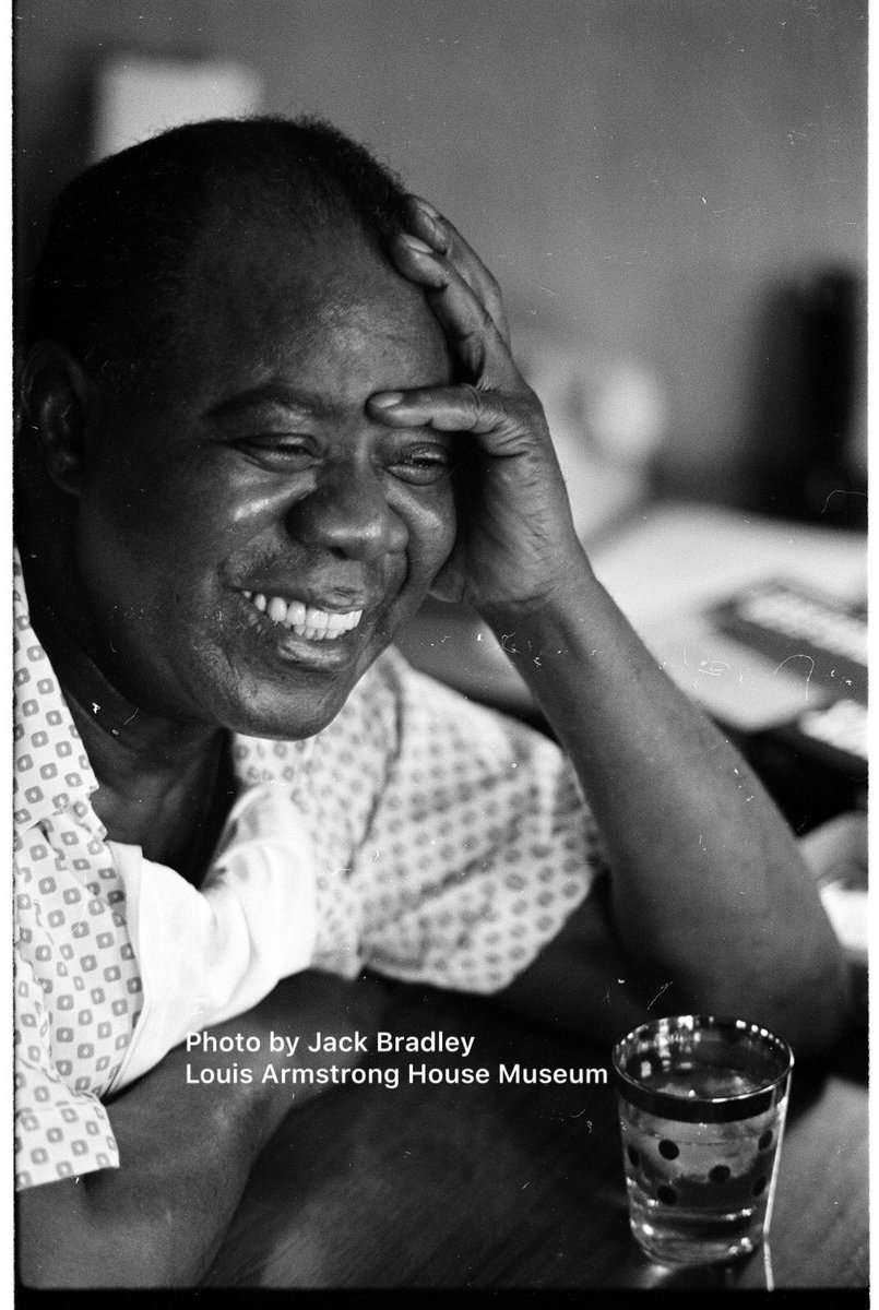 ArmstrongHouse's tweet photo. Pops in his den on this day in 1965, enjoying a glass of Slivovice plum brandy while being interviewed by Dan a Morgenstern for “Downbeat” magazine. Another beautiful photo by Jack Bradley, recently scanned from the original negative. #LouisArmstrong #LAHMDigitization #DailyPops https://t.co/n1OzYPr2sS