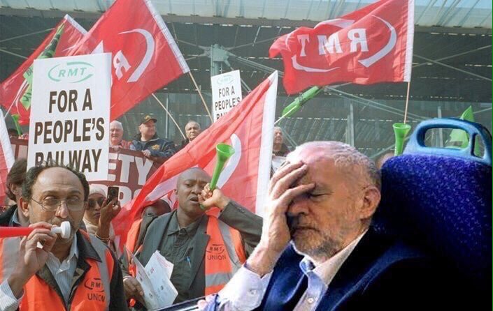 Jeremy Corbyn sits on a train with his head in his hands.