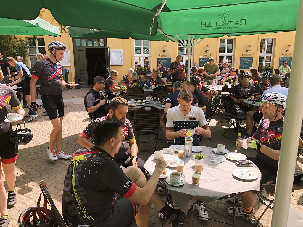 ClubPeloton's tweet photo. Break time at 70km - we’re ten minutes ahead of schedule! | @RoadsideTeam treatments and cake #livingthelife 👑 @BCO_UK @BCO_NextGen #BCOCycletoBerlin #BCORide2018 https://t.co/U2FTTVCO6B