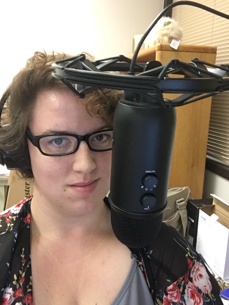 Me, wearing headphones with a microphone suspended in front of me