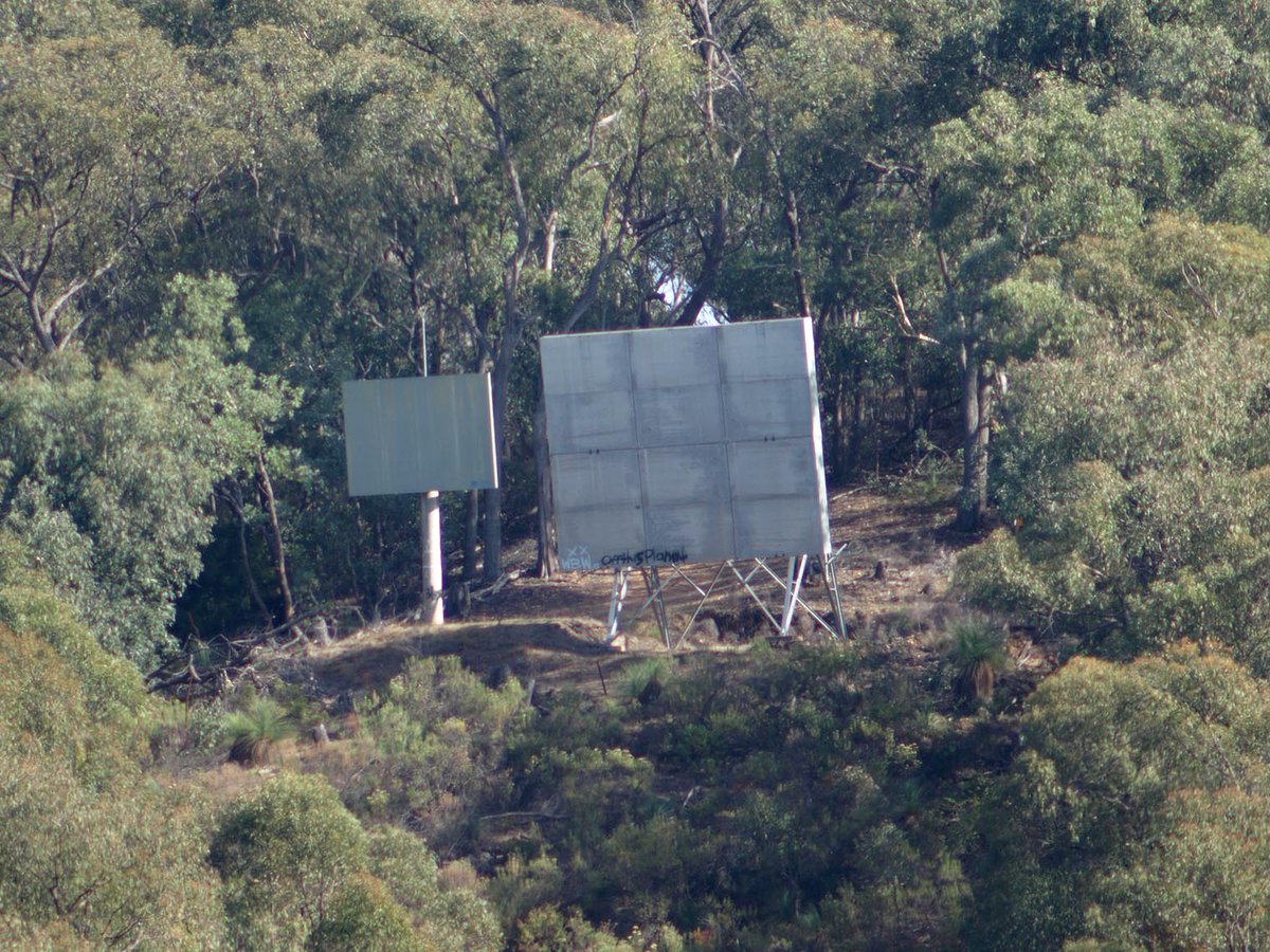 damspics's tweet photo. The view from the #Blowering #Dam wall says quite simply, valley. On the left hill is something quite intriguing. It appears to be aimed at the site office. I wonder what it's about. https://t.co/gUJNsSOvjt