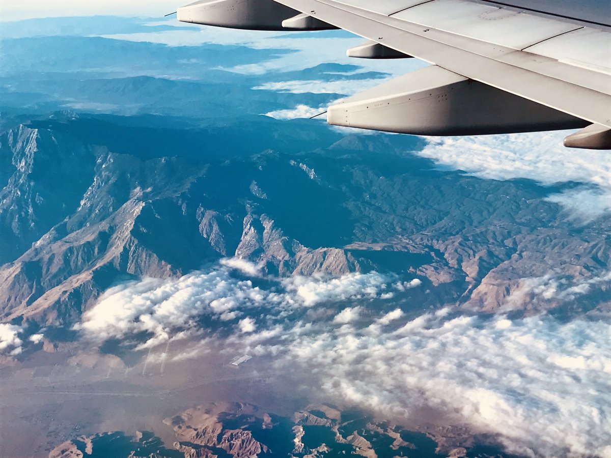 kimbrieldean's tweet photo. Somewhere between Texas and California, on the way to #ISDC2018 this morning! #rainbows #cloudsandmountains #americanairlines https://t.co/o7Cz7VAJ0G