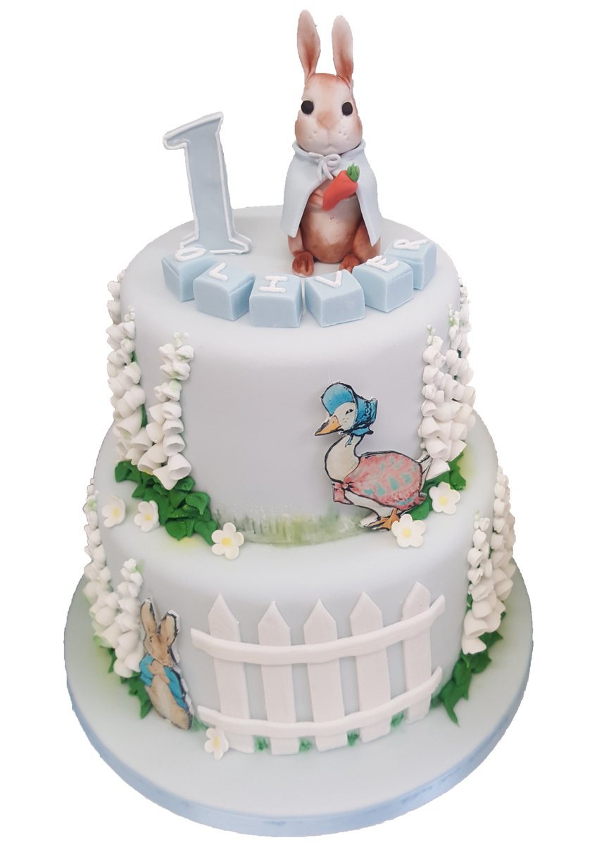 DorringtonsLtd's tweet photo. Cake of the Week: Here at Dorringtons we can create beautiful bespoke first birthday cakes. We love this 2 tier Beatrix Potter cake we created using the classic illustrations of Peter Rabbit and Jemima Puddle-Duck. https://t.co/Bi42fw6cjD
