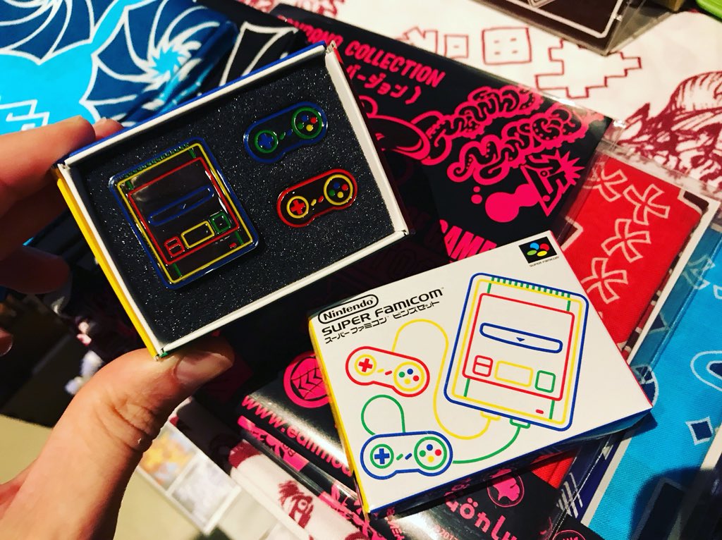 iam8bit's tweet photo. Very excited to be @bitsummit neighbors with @EDITMODE_KYOTO / The King of Games. They make INCREDIBLE video game clothing, badges, etc. Go buy everything from them! Just look at this Super Famicom pin set! That box! OMG!! 😆 👍 https://t.co/B3vYuBLAW5