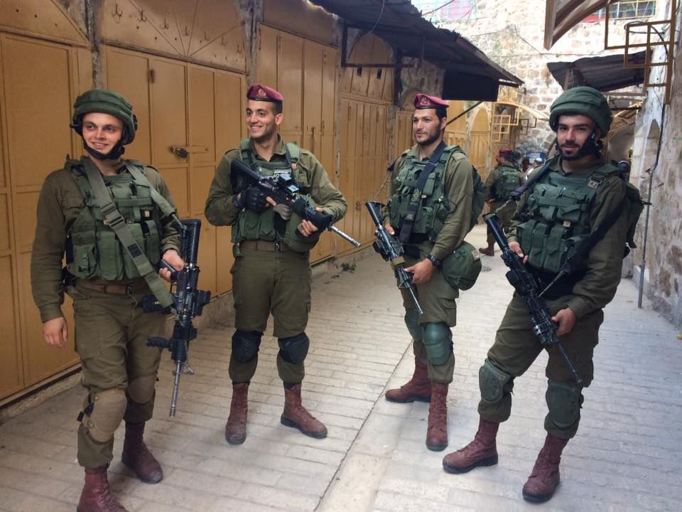 ISMPalestine's tweet photo. Israeli soldiers block path in Old Souk, occupied #alkhalil #hebron yesterday during settler tour. https://t.co/pQr2K5dada