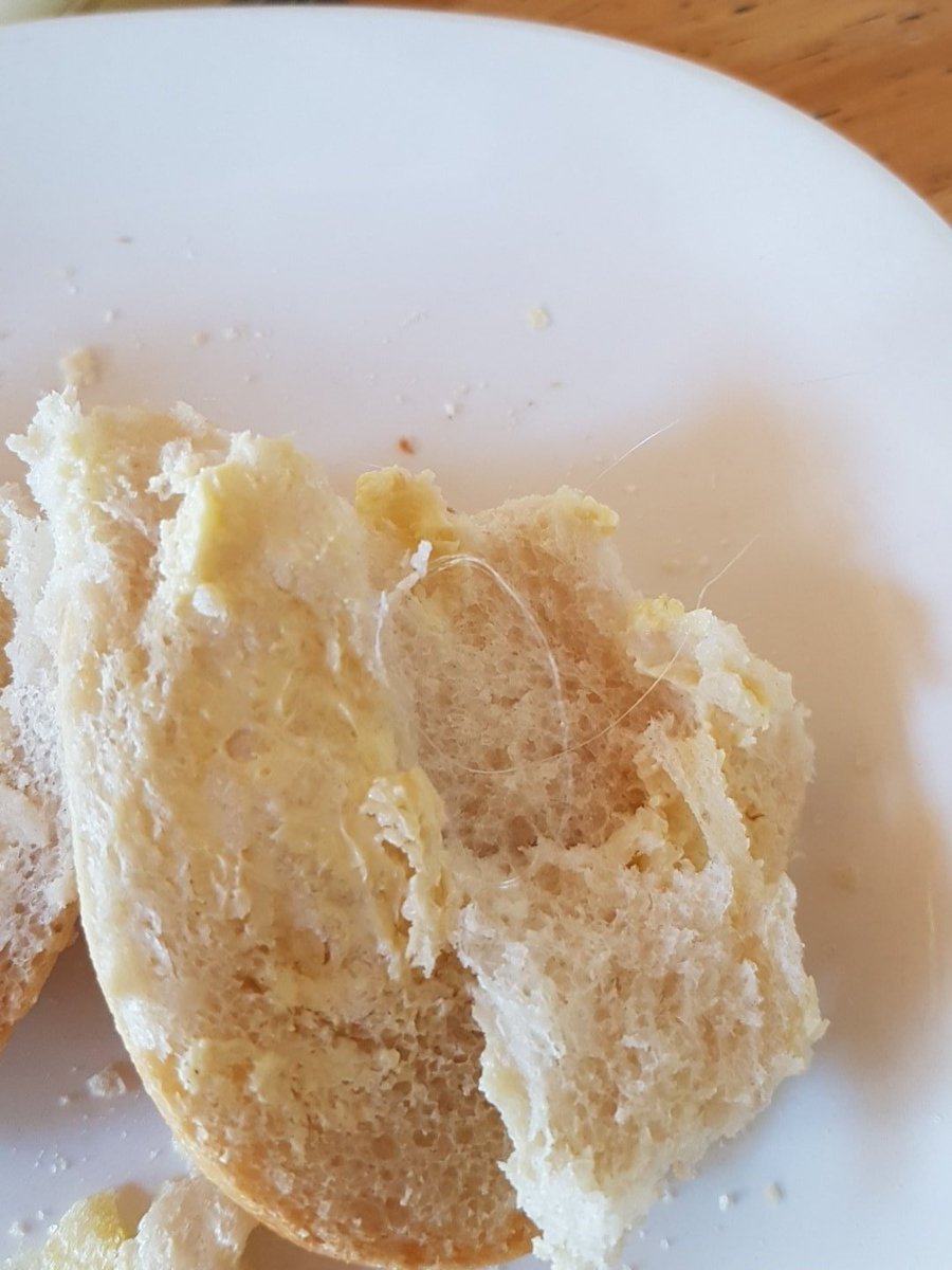MadBermo's tweet photo. Eating a roll and find this in a #cuisinedefrance roll lucky wasn't a child eating it feels like plastic melted or thread 😡😡 https://t.co/nNyC2XmK61