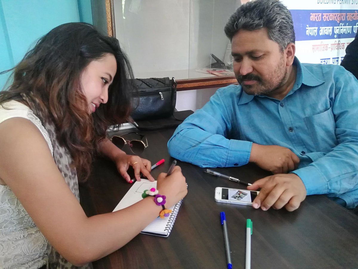 UNDPNepal's tweet photo. Help me draw a map for my new house: Kishor Jung Thapa, a local resident in Gorkha, consults architect Samjhana Shrestha at the #BuildingPermitStudio, a joint initiative of UNDP & Gorkha Municipality w/ Govt of India support. @IndiaInNepal https://t.co/rmuMoFCsrd